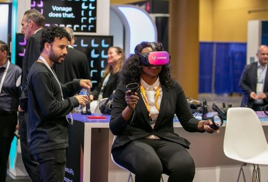 Conference attendee wearing VR glasses in the Expo Hall