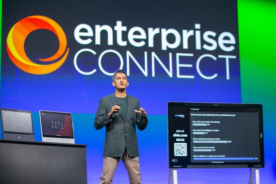 A Keynote speaker from Cisco speaks on the Enterprise Connect stage, in front of the Enterprise Connect logo on a blue background